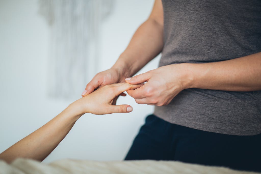 Holistic massage therapist in Cornwall. Close-up of a hand massage in a calming spa environment. Touch Therapy